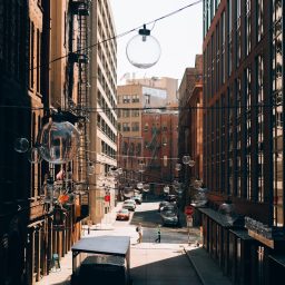 City street with buildings and decorative spheres.